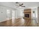 Spacious living room features hardwood floors, brick fireplace, ceiling fan, and natural light at 1209 James Ter, Daytona Beach, FL 32117