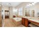 Upscale bathroom featuring double vanities, a large tub, a separate shower, and a vanity area at 123 Ivydale Manor Dr, Deland, FL 32724