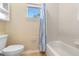 Bright bathroom with a tiled shower and tub combination, with window providing natural light at 123 Ivydale Manor Dr, Deland, FL 32724