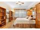 Inviting bedroom with tray ceilings, a large window with curtains, and a comfortable queen-size bed at 123 Ivydale Manor Dr, Deland, FL 32724