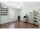 Bedroom featuring wood floors, a window with blinds, and decorative shelves at 123 Ivydale Manor Dr, Deland, FL 32724
