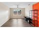 Spacious bonus room with modern fan, wood floors, and contemporary shelving at 123 Ivydale Manor Dr, Deland, FL 32724