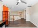 Open bonus room with wood floors, modern fan, and orange barn door at 123 Ivydale Manor Dr, Deland, FL 32724