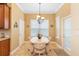Bright breakfast nook with a charming chandelier and views of the backyard through large windows at 123 Ivydale Manor Dr, Deland, FL 32724