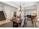Elegant dining area showcasing a wooden table, chandelier, and a cozy fireplace at 123 Ivydale Manor Dr, Deland, FL 32724