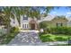 Charming two-story home featuring a stone entryway and a well-manicured front lawn at 123 Ivydale Manor Dr, Deland, FL 32724