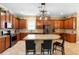 Well-equipped kitchen with stainless steel appliances, granite countertops, and a large center island with seating at 123 Ivydale Manor Dr, Deland, FL 32724