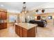 Open concept kitchen with granite island flows into the living area at 123 Ivydale Manor Dr, Deland, FL 32724