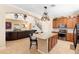 Open kitchen flows into the living area, featuring a large island with granite countertops and modern appliances at 123 Ivydale Manor Dr, Deland, FL 32724
