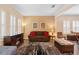 Cozy living room featuring wood floors, ample seating, and bright natural light at 123 Ivydale Manor Dr, Deland, FL 32724