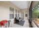 Cozy screened patio with comfortable seating, grill, and a view of the green outdoors at 123 Ivydale Manor Dr, Deland, FL 32724