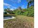 A spacious backyard enveloped by lush greenery, providing a serene and private outdoor space at 1408 W Wellington Dr, Deltona, FL 32725
