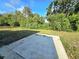 Expansive backyard offering lush greenery and a concrete patio, perfect for outdoor entertaining at 1408 W Wellington Dr, Deltona, FL 32725