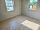 Sunlit bedroom with tile flooring and a light neutral color palette at 1408 W Wellington Dr, Deltona, FL 32725