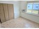 Cozy bedroom with tiled flooring, built in AC, and a window at 1408 W Wellington Dr, Deltona, FL 32725