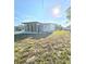 Charming single-story home featuring a screened-in porch and well-maintained lawn at 1408 W Wellington Dr, Deltona, FL 32725
