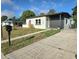 Charming single-story home featuring a modern color scheme and well-maintained landscaping at 1408 W Wellington Dr, Deltona, FL 32725