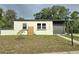 Charming single-story home featuring a modern color scheme and well-maintained landscaping at 1408 W Wellington Dr, Deltona, FL 32725