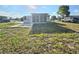 Well-maintained single-story home featuring a screened-in porch and spacious front yard at 1408 W Wellington Dr, Deltona, FL 32725