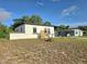 Well-maintained single-story house with a well manicured lawn at 1408 W Wellington Dr, Deltona, FL 32725