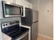 Well-equipped kitchen featuring stainless steel appliances, sleek countertops, and white cabinets at 1408 W Wellington Dr, Deltona, FL 32725