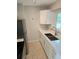 Modern kitchen featuring white cabinets, quartz countertops, and stainless steel appliances at 1408 W Wellington Dr, Deltona, FL 32725