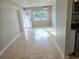 Bright open-concept living space featuring neutral walls, tile floors, and natural light at 1408 W Wellington Dr, Deltona, FL 32725