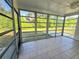 Enclosed patio with tiled flooring and a view of the outdoor space at 1408 W Wellington Dr, Deltona, FL 32725