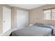 Bedroom showcasing neutral decor, sliding closet doors, and a large window at 14634 Brightwell Ct, Orlando, FL 32824