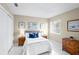 Cozy bedroom featuring neutral walls, white tile floors, and calming decor at 14634 Brightwell Ct, Orlando, FL 32824