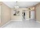 Bright dining area with tile flooring and neutral color palette, and a view of the kitchen area at 14634 Brightwell Ct, Orlando, FL 32824