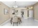 Inviting dining room with modern lighting fixture and neutral color palette, adjacent to the kitchen at 14634 Brightwell Ct, Orlando, FL 32824