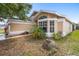Tan single Gathering home with manicured landscaping and large bay window at 14634 Brightwell Ct, Orlando, FL 32824