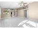 Bright living room featuring tile flooring, neutral walls, and modern ceiling fan with light fixture at 14634 Brightwell Ct, Orlando, FL 32824