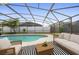 Inviting screened-in pool area with outdoor seating and lush greenery at 14634 Brightwell Ct, Orlando, FL 32824