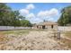 Spacious backyard featuring a patio area, privacy fence, and potential for creating an outdoor oasis at 149 Angeles Rd, Debary, FL 32713