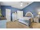 Bright bedroom featuring a large bed with a tufted headboard and matching dressers at 149 Angeles Rd, Debary, FL 32713