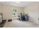 Bright bedroom with large window, desk, and exercise equipment at 149 Angeles Rd, Debary, FL 32713