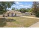 Charming single-story home featuring a well-manicured lawn and a welcoming front porch with seating at 149 Angeles Rd, Debary, FL 32713