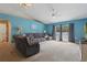 Bright living room featuring vaulted ceilings, a ceiling fan, and a sliding glass door at 149 Angeles Rd, Debary, FL 32713