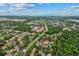Aeral view of the community, pool, manicured grounds, lush trees, and the Intercoastal Waterway in the distance at 1601 Big Tree Rd # 1301, South Daytona, FL 32119