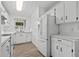 Bright kitchen featuring white cabinets, white appliances and wood-look flooring at 1601 Big Tree Rd # 1301, South Daytona, FL 32119