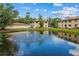 Exterior view of a pond with fountain feature on a sunny day, reflecting the surrounding building at 1601 Big Tree Rd # 1301, South Daytona, FL 32119