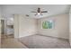 Cozy bedroom featuring neutral carpet, a ceiling fan, and a window with a green view at 1601 Big Tree Rd # 1302, South Daytona, FL 32119