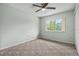 Bedroom featuring carpet, ceiling fan, and a window overlooking the yard at 1601 Big Tree Rd # 1302, South Daytona, FL 32119