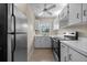 Spacious kitchen with stainless steel appliances, white cabinets, and tile flooring at 1601 Big Tree Rd # 1302, South Daytona, FL 32119