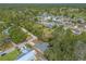 Neighborhood aerial showcasing tree lined streets, community pool, nearby golf course, and residential homes at 1617 Tuscaloosa Ave, Daytona Beach, FL 32117
