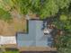 Bird's eye view of the house with a well-manicured lawn, driveway, and patio area surrounded by trees at 1617 Tuscaloosa Ave, Daytona Beach, FL 32117