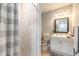 Bathroom featuring tiled walk-in shower, toilet, vanity and a decorative mirror at 1617 Tuscaloosa Ave, Daytona Beach, FL 32117