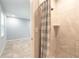 Tiled shower with a modern showerhead and a view into the light and airy space of the bathroom at 1617 Tuscaloosa Ave, Daytona Beach, FL 32117